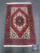 A Tabriz rug, the central strawberry medallion upon an ivory field of serrated leaf motifs,