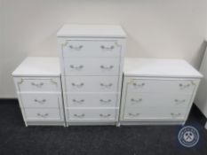 A white and gilt five drawer chest with two matching three drawer chests