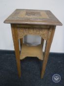 An antique carved pine occasional table