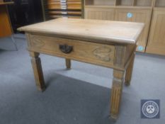 An early 20th century oak side table fitted a drawer