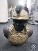 A painted concrete bust of a Roman soldier