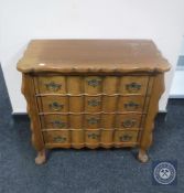 A continental oak four drawer shaped front chest