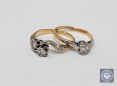 An 18ct gold diamond solitaire ring and an 18ct gold diamond crossover ring