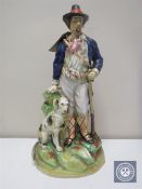 A late 19th century Staffordshire figure of a huntsman with dog