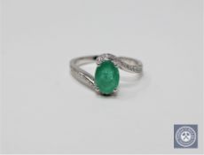 A 14ct white gold emerald and diamond ring featuring an oval cut emerald 1.