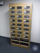 An early 20th century haberdasher's cabinet fitted twenty-four drawers (four lower drawer missing)