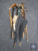 A bundle of assorted walking sticks and parasols,