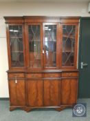 A reproduction mahogany breakfront bookcase,