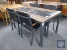 A teak metal based garden table with two inset stone panels and eight metal framed teak armchairs