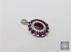 A 14ct white gold ruby and diamond pendant,