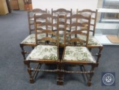 A 1930's oak pull out dining table together with a set of five oak ladder back chairs