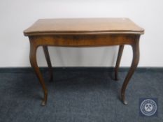 A late 19th century mahogany turnover top tea table on cabriole legs