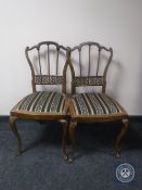A pair of early 20th century mahogany bedroom chairs on cabriole legs