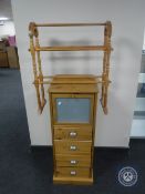 A pine four drawer chest fitted a cabinet together with pine towel rail