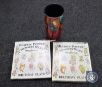 A Poole pottery vase and two boxed Beatrix Potter plates by Wedgwood