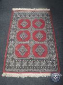 A Bokhara design rug on red ground,