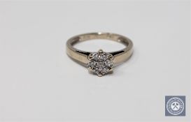 An 18ct gold diamond flower cluster ring, approximately 0.25ct, size L 1/2.
