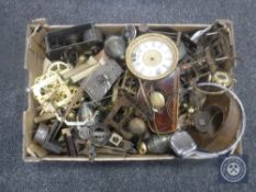A box of assorted clock movements and parts
