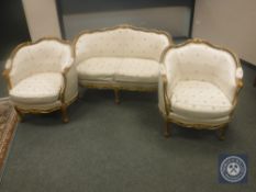A reproduction three piece salon suite comprising two seater settee and pair of armchairs