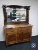 An Edwardian oak Arts & Crafts mirror back sideboard