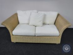 A wicker conservatory two seater settee