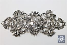 An Art Nouveau pierced white metal belt buckle, bearing spurious continental hallmarks, width 14.
