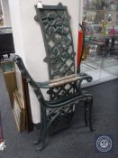 A pair of antique cast iron bench ends and back