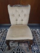A bedroom chair upholstered in a buttoned dralon