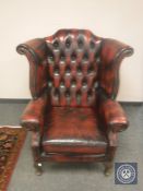 A oxblood leather Chesterfield armchair,