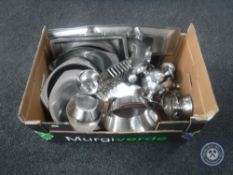 A box of stainless steel trays and dishes