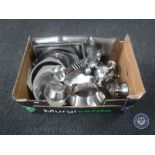 A box of stainless steel trays and dishes