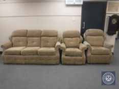 A three piece lounge suite in brown fabric