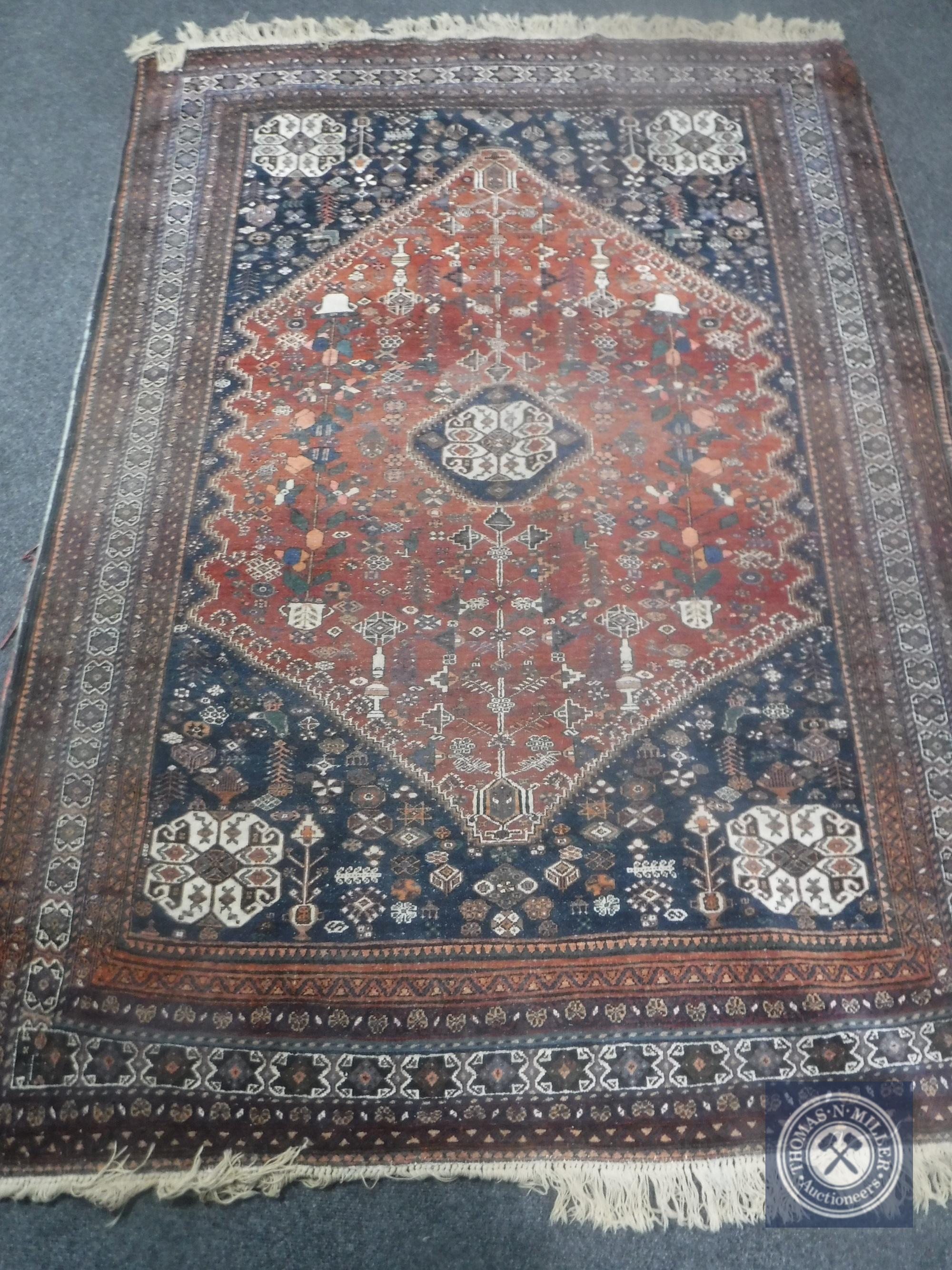 A Kashgai rug, South West Iran, with a central terracotta medallion surrounded by exotic birds,