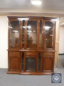 A reproduction mahogany triple door breakfront display cabinet