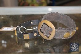 An antique leather and brass studded dog collar,