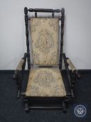 A mahogany framed tapestry upholstered American style rocking chair