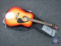 A Yamaha F310 CS acoustic guitar in gig bag