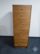 A mid 20th century narrow teak eight drawer chest