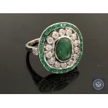 An 18ct white gold emerald and diamond ring featuring an oval cut emerald 2.