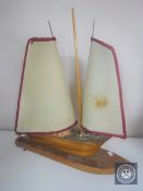 A mid 20th century teak table lamp in the form of a yacht