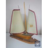 A mid 20th century teak table lamp in the form of a yacht