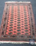 A Bokhara design rug on salmon ground,