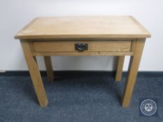 A contemporary oak hall table fitted a drawer
