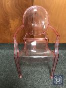 A child's pink Kartell Lou Lou ghost chair