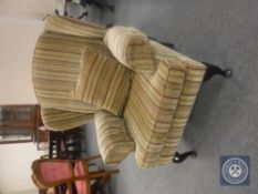 A wingback armchair in striped upholstery