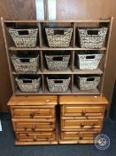 A pair of pine bedside chests and a set of pine shelves fitted with wicker baskets