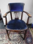 An Edwardian oak captain's armchair