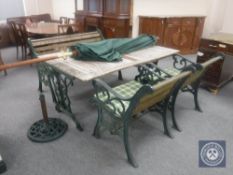 A cast iron and wood rectangular garden table together with a bench,