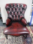 A red button leather Chesterfield style lady's chair