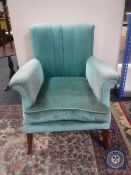 A mid 20th century armchair in turquoise fabric